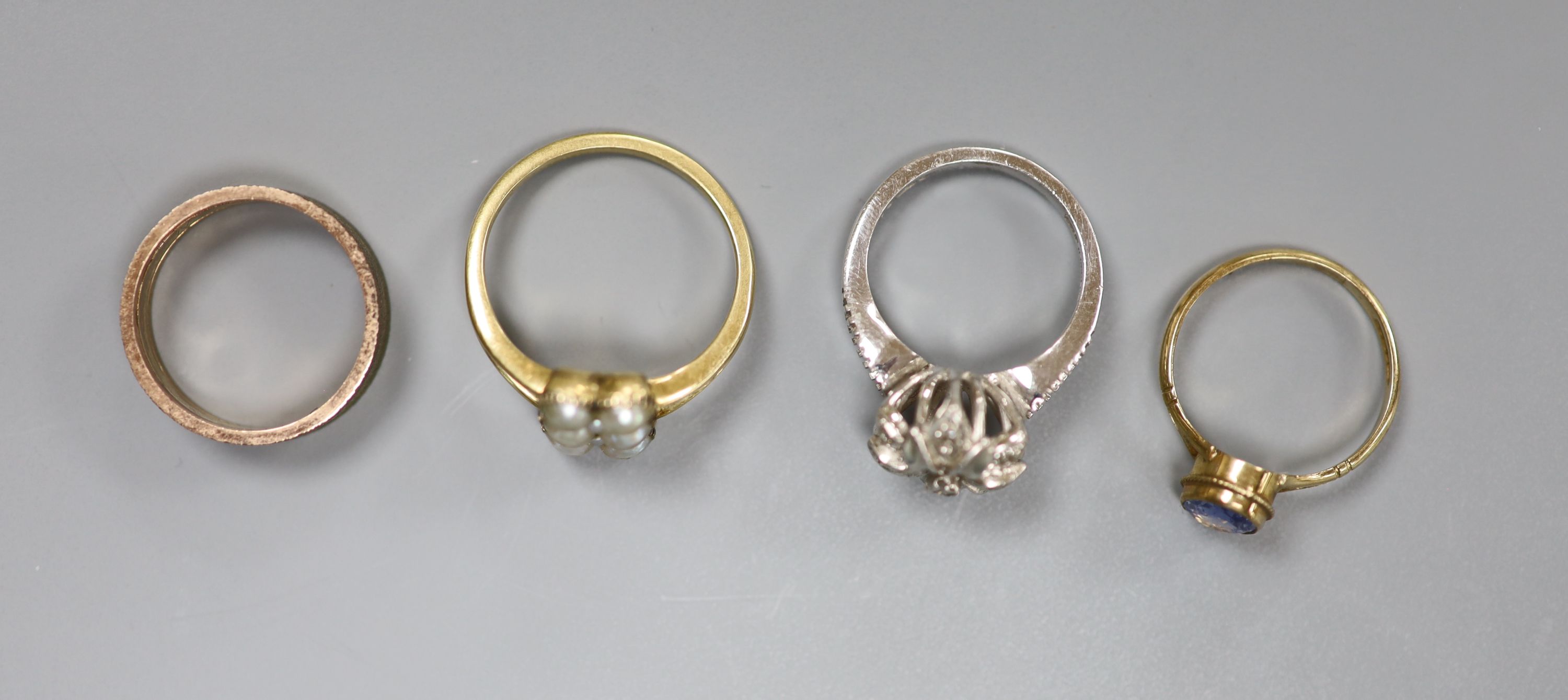 Two 9ct gold and gem set dress rings including white gold & diamond chip, a 9ct wedding band, gross 11 grams and a yellow metal and split pearl cluster ring, gross 4.4 grams.